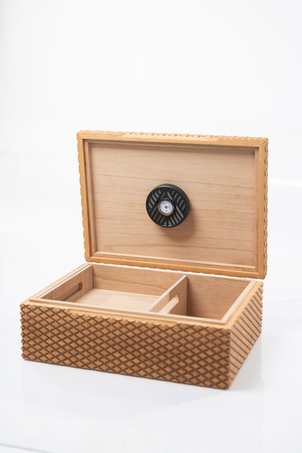 Interior of large cigar humidor, made of cherry, lined with Spanish cedar, with textured diamond pattern.