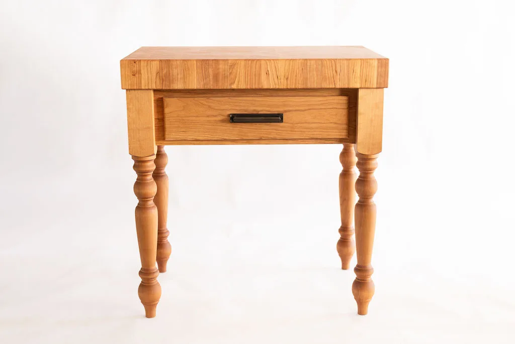 A cherry wood butcher block kitchen island with turned legs, 4" butcher block island top, and oil-rubbed bronze pulls — beth & co. woodworks, Sierra Vista, AZ