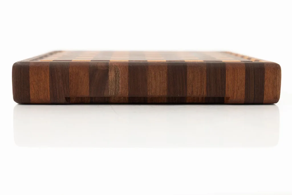Side view of a gingham patterned end-grain cutting board in cherry, walnut, and sapele — beth & co. woodworks, Sierra Vista, AZ