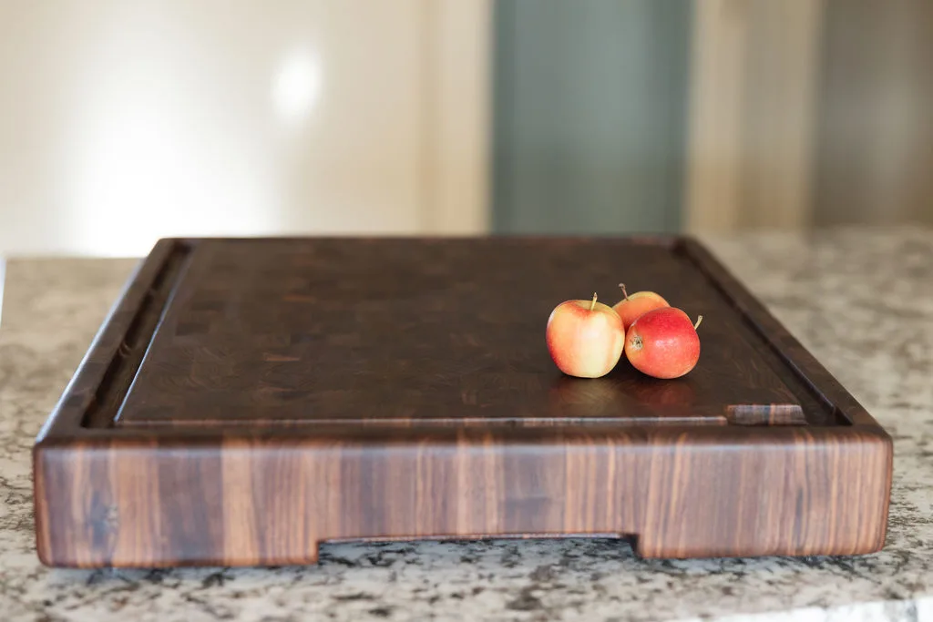 Angled view of a solid walnut end-grain cutting board showing grain pattern and natural oil finish — beth & co. woodworks, Sierra Vista, AZ