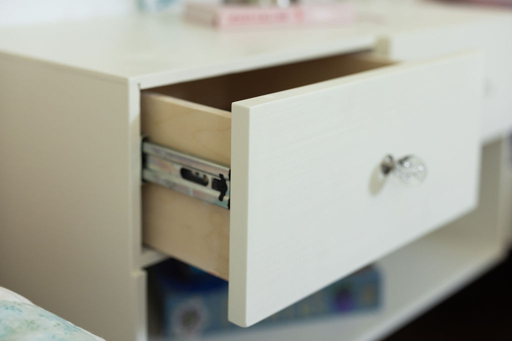 Angled view of a custom floating nightstand with drawer open showing interior storage and open shelf below in paint grade poplar — beth & co. woodworks, Sierra Vista, AZ