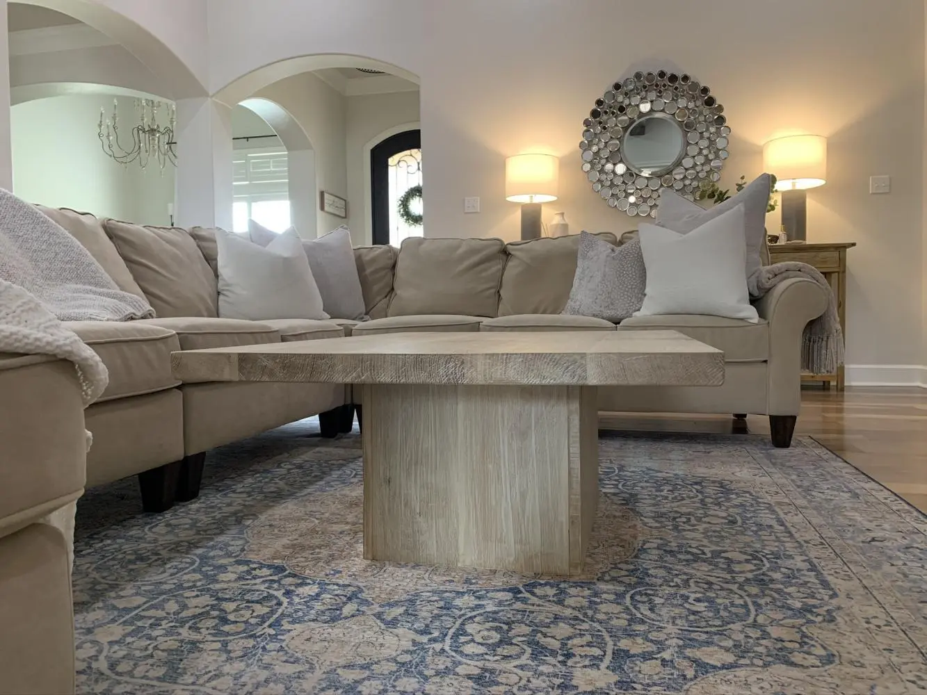 Side view of a custom hardwood coffee table in solid white oak showing architectural plinth base and 2-inch thick slab top — beth & co. woodworks, Sierra Vista, AZ