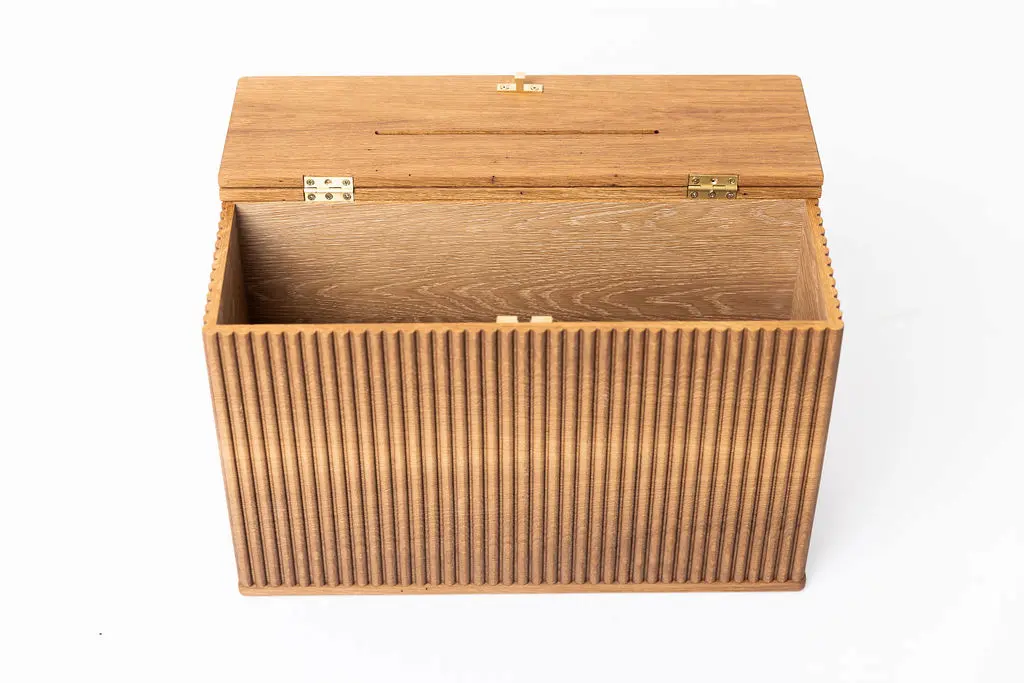 Angled view of a custom church donation box in solid white oak with fluted panels, top offering slot, and hard wax oil finish — beth & co. woodworks, Sierra Vista, AZ