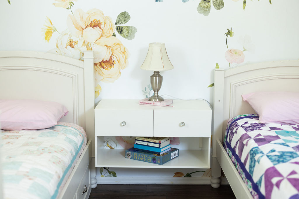 Front view of a custom white floating nightstand in paint grade poplar with drawer and open shelf mounted between two beds — beth & co. woodworks, Sierra Vista, AZ